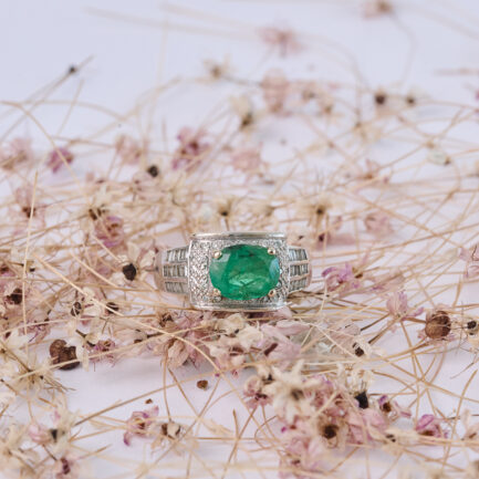 ANILLO DE ORO BLANCO CON DIAMANTES Y UNA ESMERALDA ENGARZADA EN UNA CÚPULA CON ARABESCOS